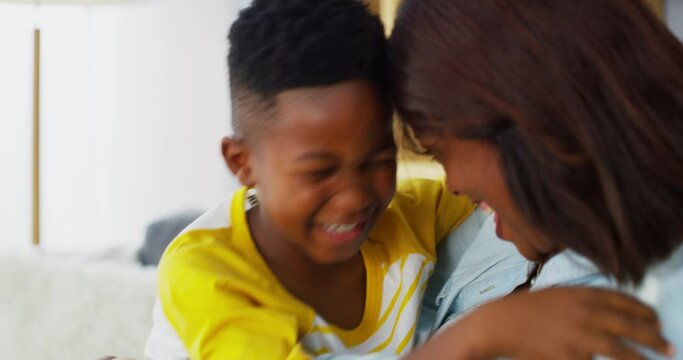 Face together, sofa and mother with child in home for bonding, happy relationship and love. Black family, parents and mom and boy smile in living room embrace for care, trust and relax on couch