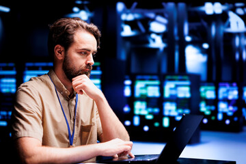 Puzzled employee thinking how to best improve supercomputers helping businesses manage databases,...