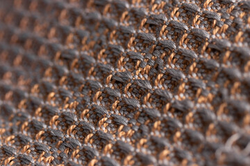 draped fabric woven using waffle weave technique in brown and gray, close up detail macro shot with...