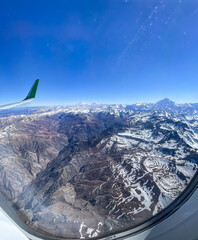 Beautiful aerial view of the plane window of the Andes mountains, cover with snow