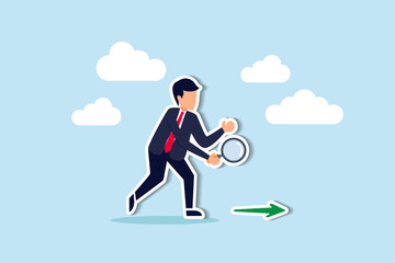 Searching for business direction, strategy or discover business opportunity or solution for work difficulty concept, businessman leader using magnifying glass to discover arrow on the floor.