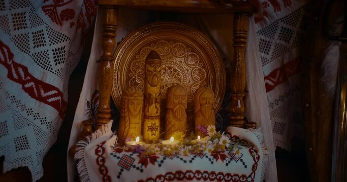 wooden idols of Slavic gods and candles in interior of ancients house, closeup view, 4K, Prores