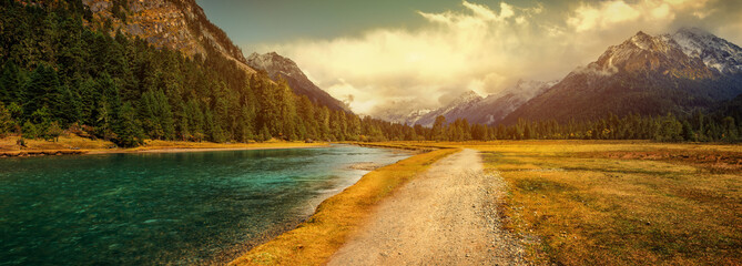 Road winding through the country valley - obrazy, fototapety, plakaty