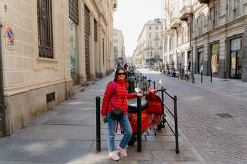 Obraz premium A girl next to a motorcycle in Turin.
