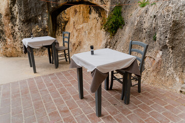 Empty tables in a street cafe. Cafe by the sea.