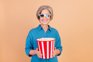 Photo of cheerful woman with bob hairdo dressed blue shirt in 3d glasses hold popcorn at cinema...