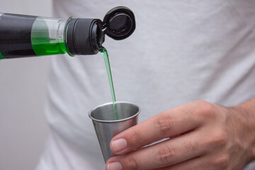 Hand pouring green drink