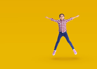 Fototapeta na wymiar Cute girl jumping on golden background, space for text