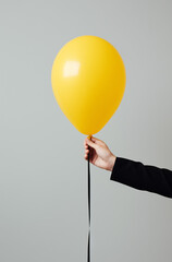 hand holding a yellow balloon.Minimal party concept.Copy space.Generative Ai