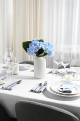 Beautiful table setting with floral decor indoors
