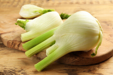 Fresh raw fennel bulbs on wooden table, closeup