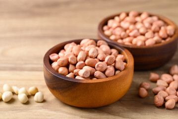 Peanut in bowl on wooden background