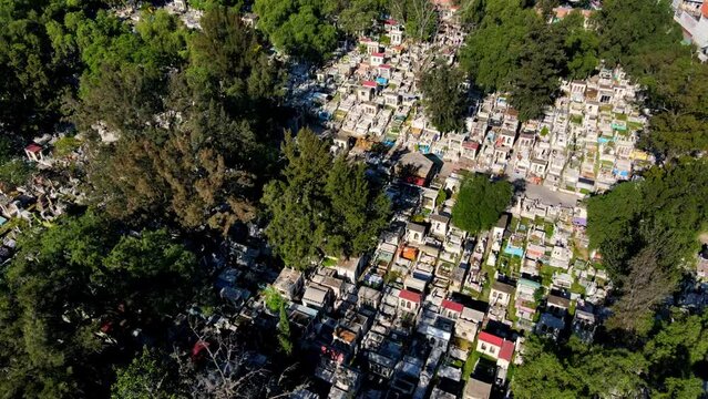 Aerial orbit of the tombstones of the General Cemetery of Iztapalapa on a sunny day in CDMX, Mexico.