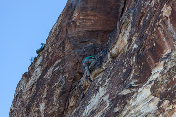 Rock Climber Reaching Ledge on Rock Wall