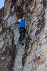 Rock Climber Reaching for Hand Hold