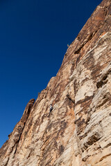 Two Rock Climbers High on a Cliff