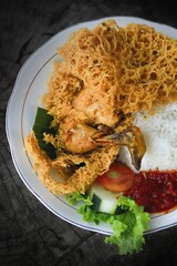 Flour fried chicken with rice and additional cucumber slices and chili sauce ready to eat