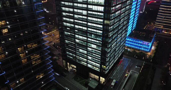 illuminated windows of office building at night
