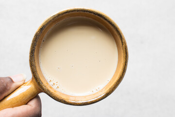Top view of evaporated milk in a brown ceramic ramekin, vegan and alternative milk in a ceramic...