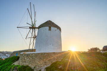 Fototapeta na wymiar Famous windmill of Mykonos island with sun flare 