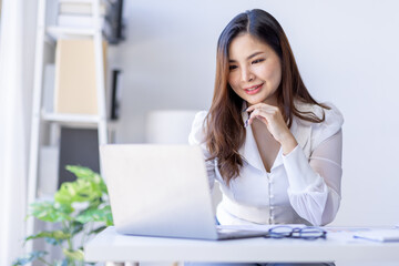 Young business asian woman work on desk busy on documents and  laptop accountant office business financial concept.