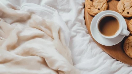 Foto op Plexiglas Cookies and cappuccino cup  resting on a white bedsheet with a knitted blanket. A cozy, warm, and soft flatlay depicting a morning routine. Ample copy space. Minimalism concept. © Bee