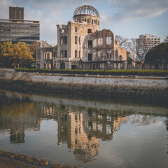 Atomic Bomb Dome and its reflection in the river that flows nearby in Japan.