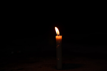 candles in the dark, flame of a candle burning in the dark