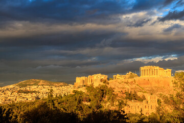 View of the Acropolis Hill, crowned with Parthenon during evening golden hour from the Philopappos...