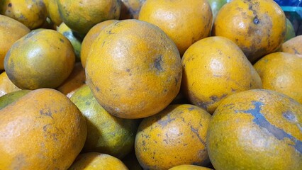 Close up pile of tasty fresh oranges sold at the market as a background.