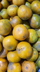 Close up pile of tasty fresh oranges sold at the market as a background.