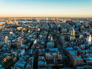 Aerial wide angle view of Manhattan buildings, New York City at sunset,  Brooklyn on the horizon