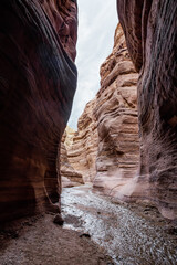 Bizarre  patterns of high mountains near a shallow stream at beginning of the Wadi Numeira hiking trail in Jordan