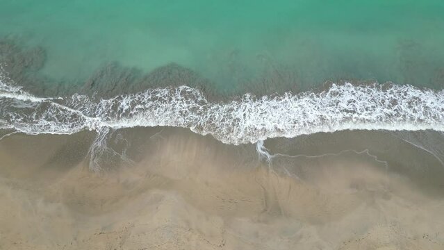 waves crashing on a beach (drone shot from above looking down) nobody, empty, idyllic tropical paradise view (luquillo puerto rico)  caribbean island travel destination for the holidays