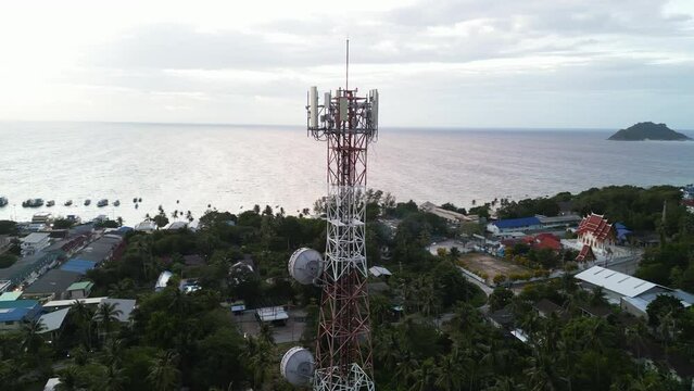 Aerial view of Koh Tao ferry terminal and town, Sairee Beach view at sunset, Telecommunication mobile tower at beach island