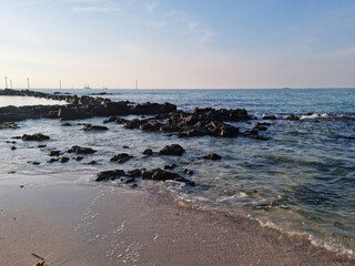 It is a beach with basalt rocks.