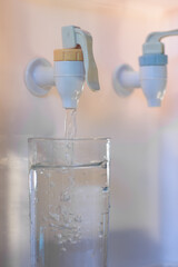 Close up plastic hot and cold water faucet in natural light background.