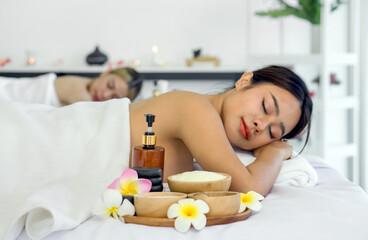 Obraz na płótnie Canvas Woman getting spa massage. Lying on a massage table, relaxing with eye closed. Spa Thai therapy treatment aromatherapy for beauty body. Spa beauty massage healthy wellness. Side view