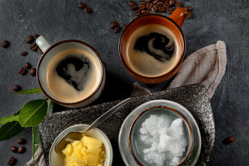 Bulletproof keto coffee. Ketogenic diet. Hot dring with coconut oil and ghee butter on dark background