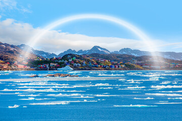 Picturesque village on coast of Greenland with amazing white rainbow - Colorful houses in Tasiilaq,...