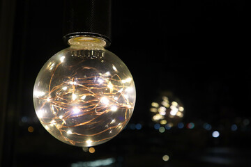 decorative beautiful light bulb in the dark night close up background