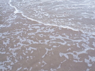 Background image: sandy beach, sea in Thailand. The sandy floor has sea waves.