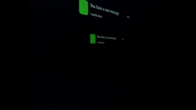 Notification Green Icon of Text Messaging, Online Messaging or E-Mail on Black Device Screen Brand Name Smart Phone show notifies that there is a new text message. 5G or Wireless technology.