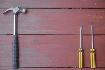 assortment of well-used hand tools spread out on a worn wooden surface, indicative of a workspace...