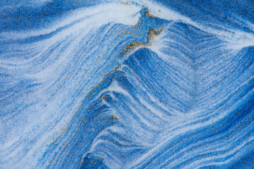 Closeup dust of pigment sparkling with blue fluid color