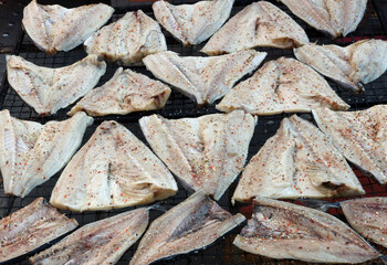 Fresh mackerel sprinkled with spices for smoking