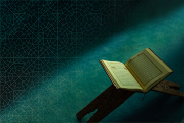 Islamic concept image. The Holy Quran on the book stand in blurry background