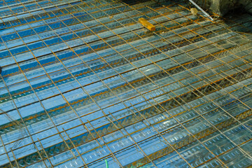 Industrial Photography. Construction works. Textured Background of wiremesh installed on top of the metal deck. Installation of wire mesh on the metal deck before casting the floor. Bandung, Indonesia