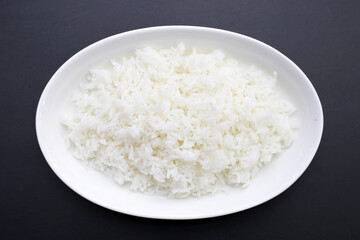 Cooked rice on dark background.