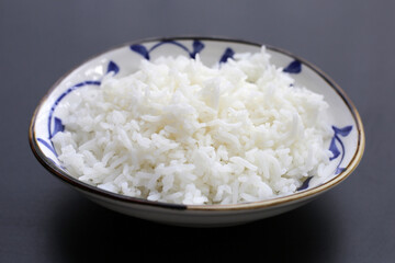 Cooked rice on dark background.